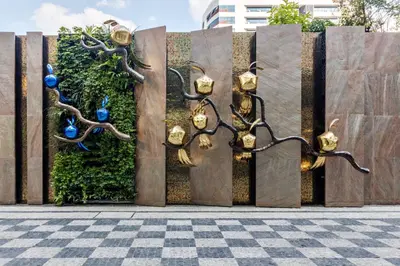 a fence with a sculpture of animals on it at Holiday Inn Express Bangkok Soi Soonvijai by IHG in Bangkok