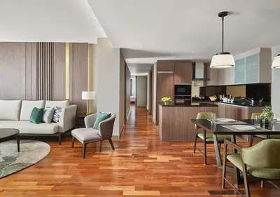 a living room with a couch and a table at Fraser Suites Sukhumvit Bangkok in Bangkok