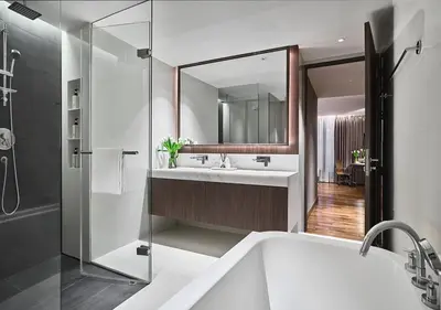 a bathroom with a tub and two sinks and a mirror at Fraser Suites Sukhumvit Bangkok in Bangkok