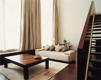 a living room with a couch and a coffee table at COMO Metropolitan Bangkok in Bangkok