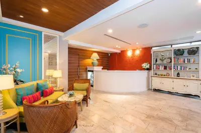 a living room with a couch and chairs and a table at La Petite Salil Sukhumvit 8 in Bangkok