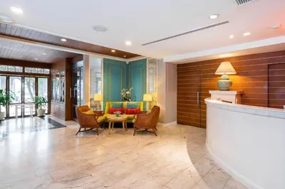 a lobby of a hotel with chairs and a table at La Petite Salil Sukhumvit 8 in Bangkok