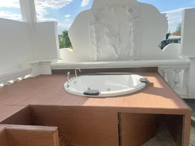 a bathroom with a bath tub on a wooden table at V20 Boutique Jacuzzi Hotel in Bangkok