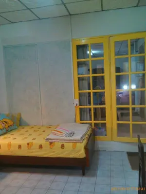 a bedroom with a bed and a sliding glass door at Social Style Culture in Bangkok