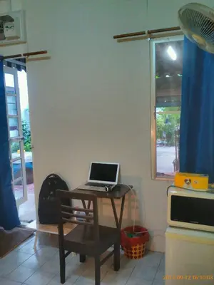 a laptop computer sitting on a table in a kitchen at Social Style Culture in Bangkok