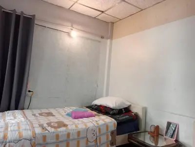 a small bedroom with a bed and a window at Social Style Culture in Bangkok