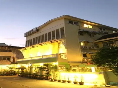 a large white building with lights on a street at Sawasdee Sukhumvit Inn in Bangkok