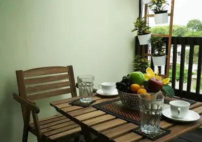 a wooden table with a bowl of fruit on it at The Serene House Bangkok in Bangkok