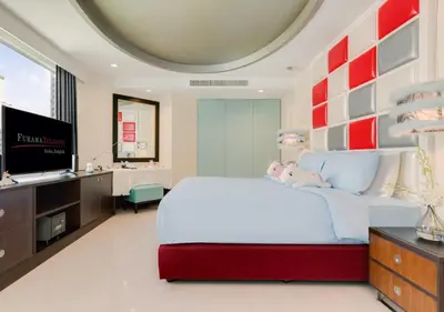 a bedroom with a large white bed and a flat screen tv at FuramaXclusive Asoke, Bangkok in Bangkok