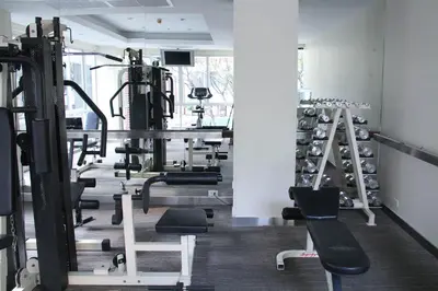 a gym with rows of treadmills and machines at FuramaXclusive Sathorn, Bangkok in Bangkok