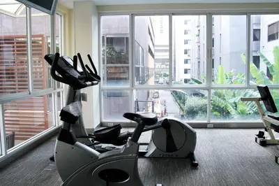 a gym with two exercise bikes in front of a window at FuramaXclusive Sathorn, Bangkok in Bangkok