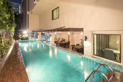 a swimming pool in the middle of a building at Aspen Suites Hotel Sukhumvit 2 in Bangkok