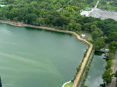 an overhead view of a lake with trees and a park at Column Bangkok Hotel in Bangkok