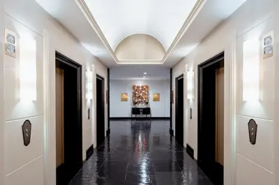 a hallway of a building with a chandelier at Grande Centre Point Hotel Ratchadamri Bangkok in Bangkok