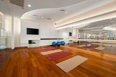a yoga room with mats on the floor at Grande Centre Point Hotel Ratchadamri Bangkok in Bangkok