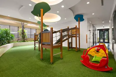 a childrens room with a playground with a bunk bed at Grande Centre Point Hotel Ratchadamri Bangkok in Bangkok