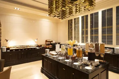 a restaurant with a buffet line with food at Grande Centre Point Hotel Ratchadamri Bangkok in Bangkok