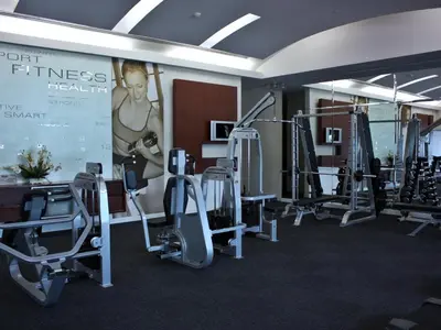 a gym with treadmills and elliptical machines at Centre Point Sukhumvit Thong-Lo in Bangkok