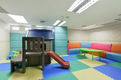 a play room with a slide and a playground at Centre Point Sukhumvit Thong-Lo in Bangkok
