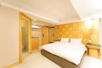 a bedroom with a large white bed in a room at UPAR Hotels Sukhumvit 11 Nana in Bangkok
