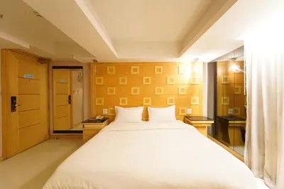 a bedroom with a large white bed in a room at UPAR Hotels Sukhumvit 11 Nana in Bangkok