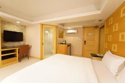 a hotel room with a bed and a television at UPAR Hotels Sukhumvit 11 Nana in Bangkok