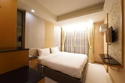 a hotel room with a bed and a window at UPAR Hotels Sukhumvit 11 Nana in Bangkok