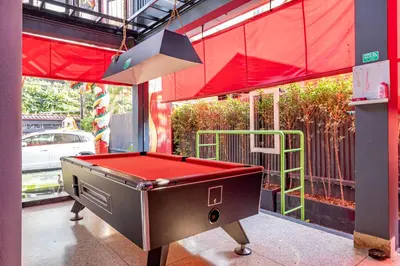 a ping pong table with a red top in a building at CLOUD on Saladaeng Silom Hostel Bangkok in Bangkok