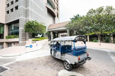 a golf cart parked in front of a building at Somerset Park Suanplu Bangkok in Bangkok