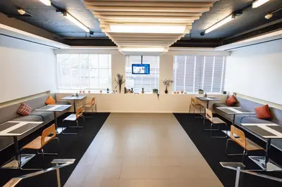 a dining room with tables and chairs and a bar at Citadines Sukhumvit 16 Bangkok in Bangkok