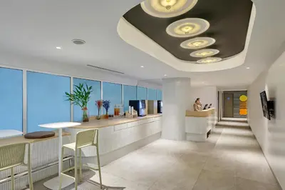 a lobby with a waiting area with a circular ceiling at Citadines Sukhumvit 16 Bangkok in Bangkok