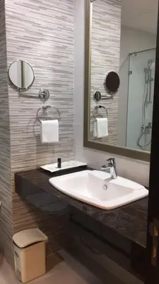 a bathroom with a sink and a mirror at Club Mahindra Mac Boutique Hotel in Bangkok