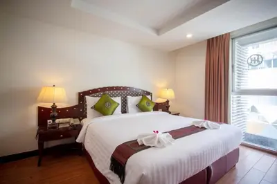 a bedroom with a large bed and a window at Nana Hiso Hotel in Bangkok
