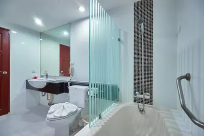 a bathroom with a toilet and a sink and a shower at Nana Hiso Hotel in Bangkok