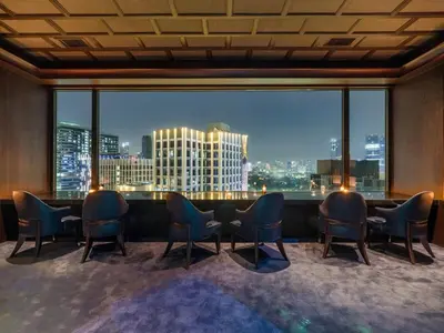 a room with a table and chairs and a large window at Crowne Plaza Bangkok Lumpini Park by IHG in Bangkok