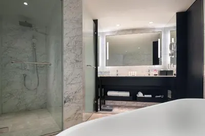 a bathroom with a shower and a glass shower stall at Crowne Plaza Bangkok Lumpini Park by IHG in Bangkok