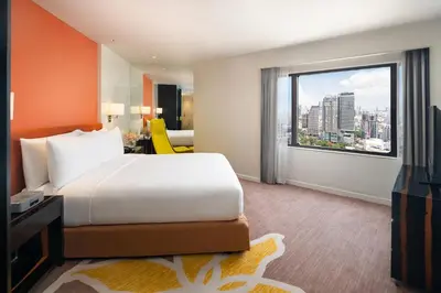 a hotel room with a bed and a large window at Crowne Plaza Bangkok Lumpini Park by IHG in Bangkok