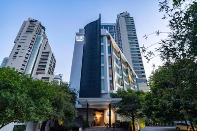 a building in front of two tall buildings at TUI BLUE Maduzi Hotel Bangkok in Bangkok