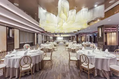 a banquet hall with white tables and chairs and a chandelier at Rembrandt Hotel Bangkok in Bangkok