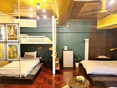 a room with two bunk beds and a table at DDM House in Bangkok