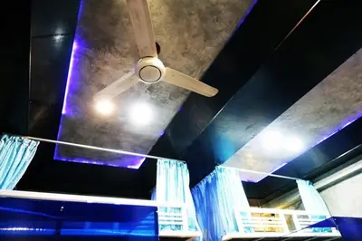 a ceiling fan in a room with a blue ceiling at DDM House in Bangkok