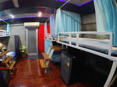 a room with two bunk beds and a tv at DDM House in Bangkok