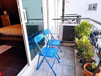 a pair of blue chairs sitting on a balcony at DDM House in Bangkok