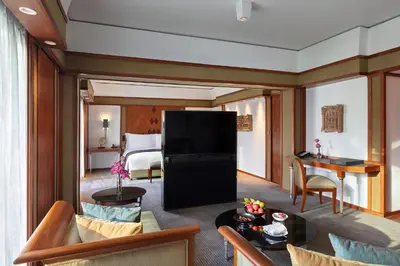 a living room with a room with a suite at The Sukhothai Bangkok in Bangkok