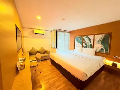 a hotel room with a bed and a couch at I Residence Hotel Silom in Bangkok