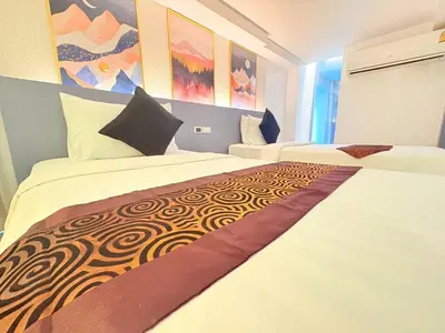 a hotel room with two beds and a painting at I Residence Hotel Silom in Bangkok