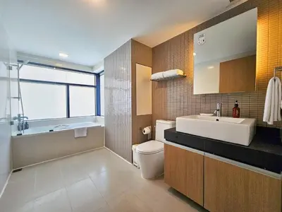 a bathroom with a sink and a toilet and a tub at Citadines Sukhumvit 8 Bangkok in Bangkok