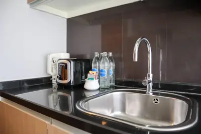 a kitchen counter with a stainless steel sink at Citadines Sukhumvit 8 Bangkok in Bangkok