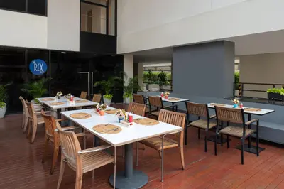 a dining room with tables and chairs in a building at Citadines Sukhumvit 8 Bangkok in Bangkok