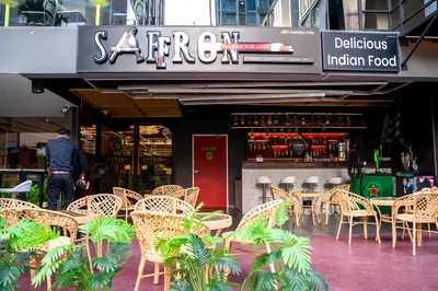 a group of tables and chairs in front of a restaurant at Citadines Sukhumvit 11 Bangkok in Bangkok